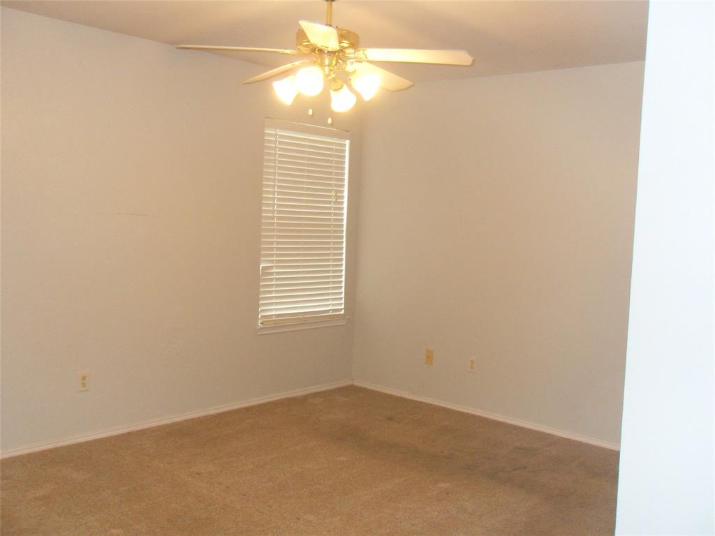 817 Cruise Street Denton, TX 76207 - Photo 10 of 13 an empty room with windows and fan
