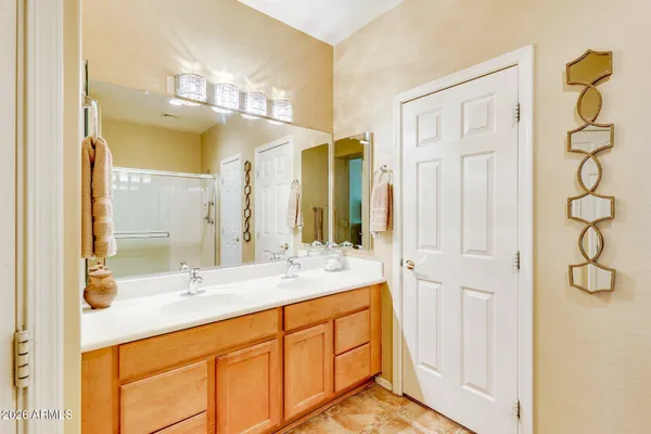 a bathroom with a double vanity sink mirror and