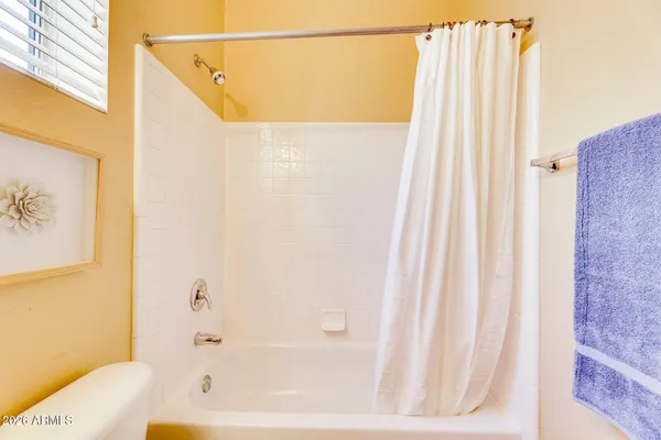 a bathroom with a shower and a tub