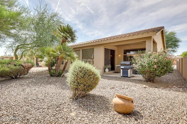 a view of a house with backyard and sitting area