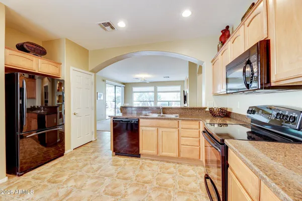 a kitchen with a sink appliances and cabinets