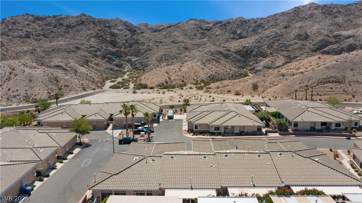 3376 Partridge Run Street Laughlin, NV 89029 - Photo 72 of 92 An aerial perspective reveals a desert community nestled at the base of striking mountain formations.