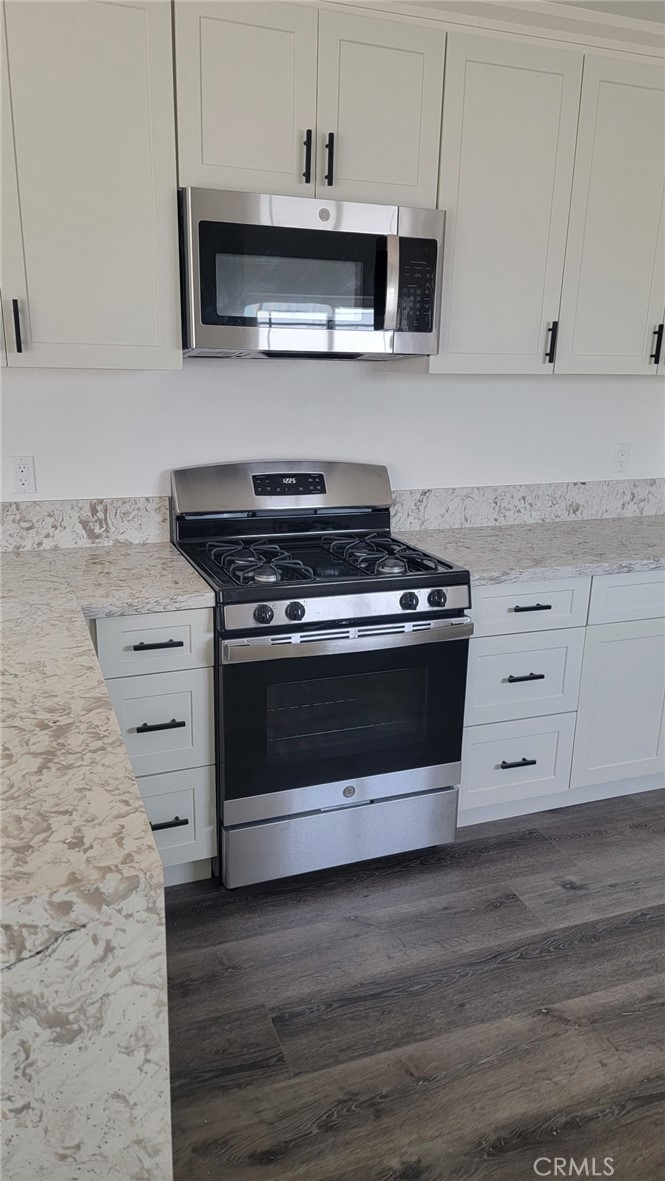 880 South State Street Hemet, CA 92543 - Photo 10 of 21 a stove top oven sitting inside of a kitchen