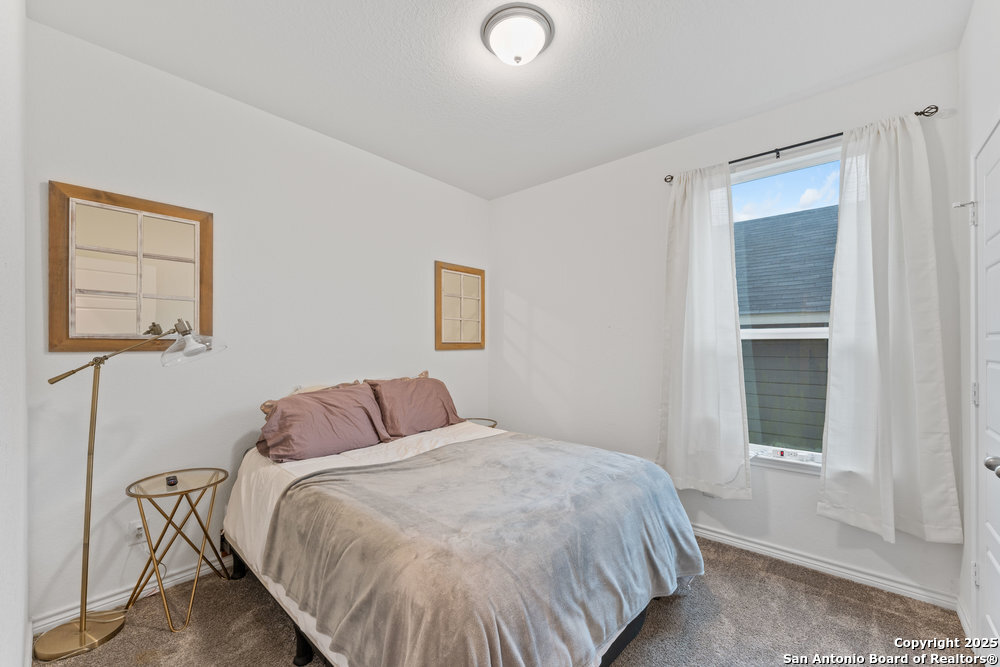 3404 Taurus Sky Converse, TX 78109 - Photo 15 of 27 a bedroom with a bed and a window