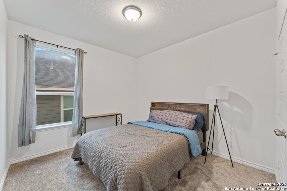 3404 Taurus Sky Converse, TX 78109 - Photo 16 of 27 a bedroom with a bed and a large window