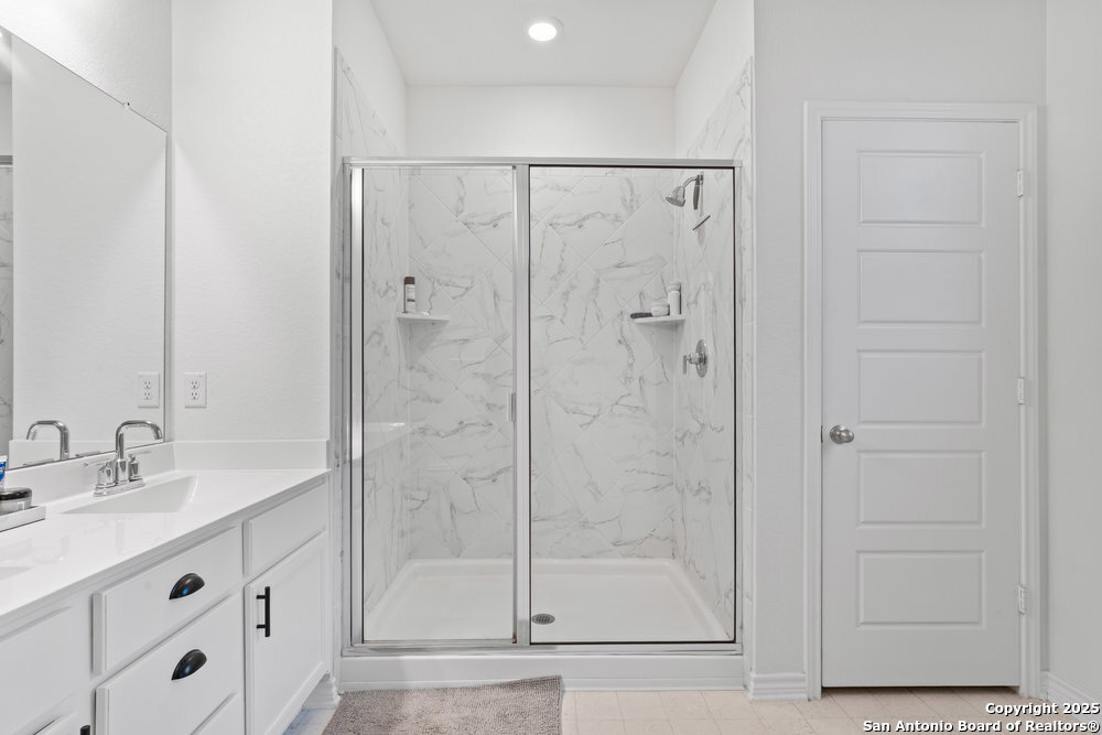 3404 Taurus Sky Converse, TX 78109 - Photo 20 of 27 a bathroom with a shower sink and mirror