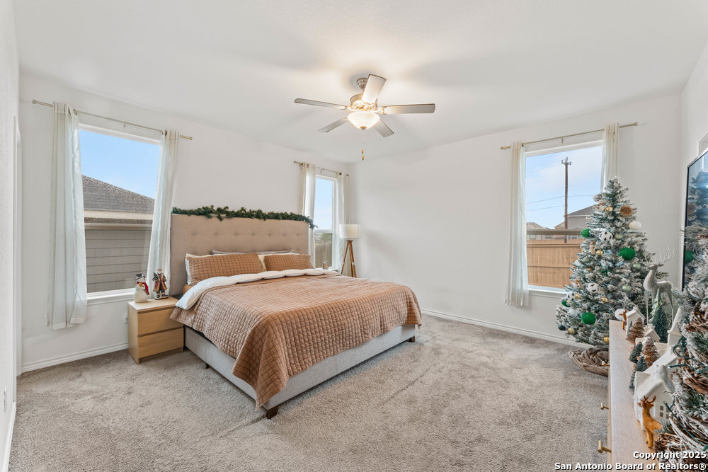 3404 Taurus Sky Converse, TX 78109 - Photo 22 of 27 a bedroom with a bed and a potted plant