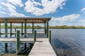 a view of a balcony with wooden floor and lake view