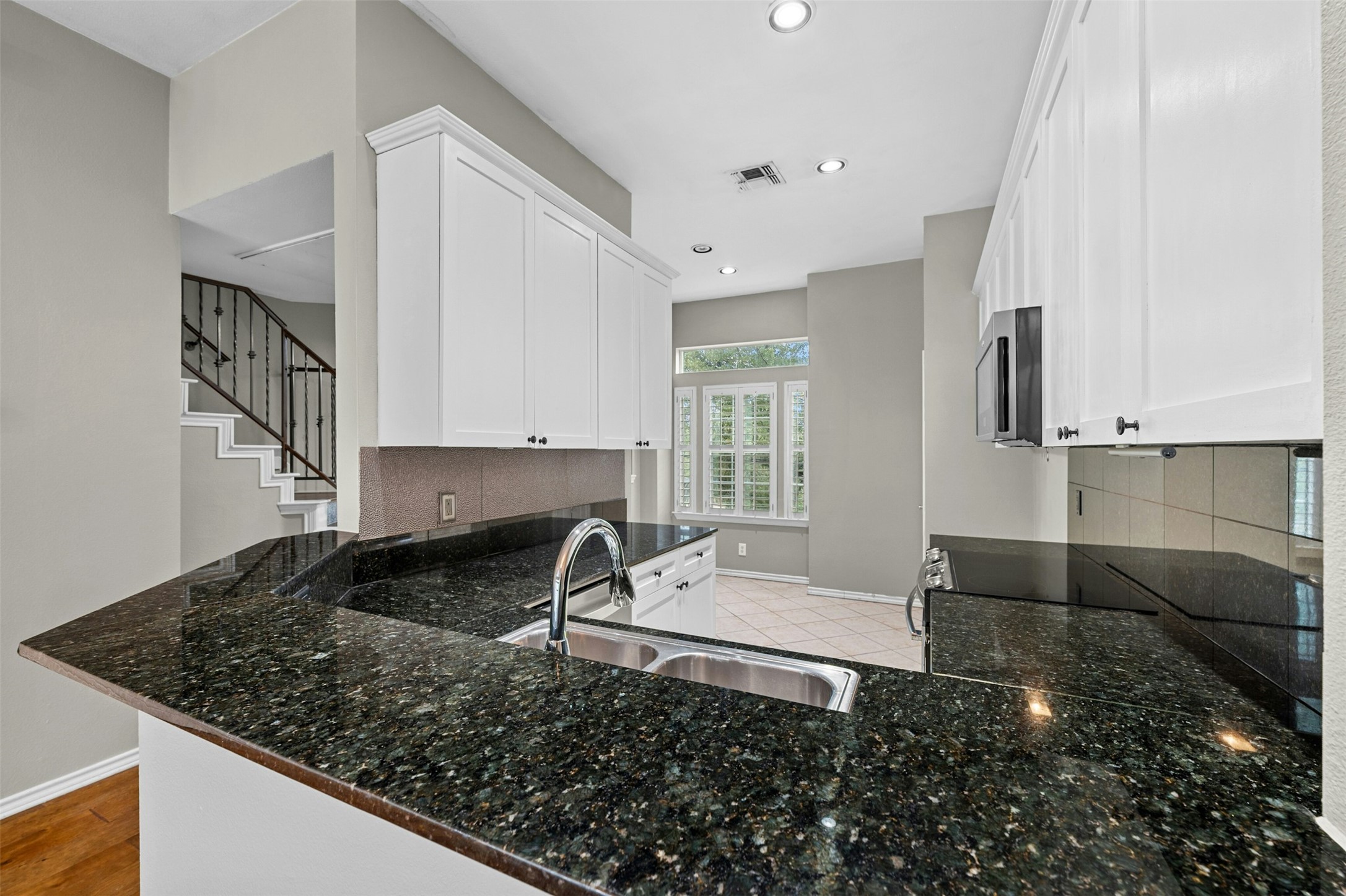 2918 Ranch To Market Road 620, Unit W219 Austin, TX 78734 - Photo 11 of 35 Enjoy granite countertops, bar seating, and a peek into the cozy breakfast nook with plantation shutters.