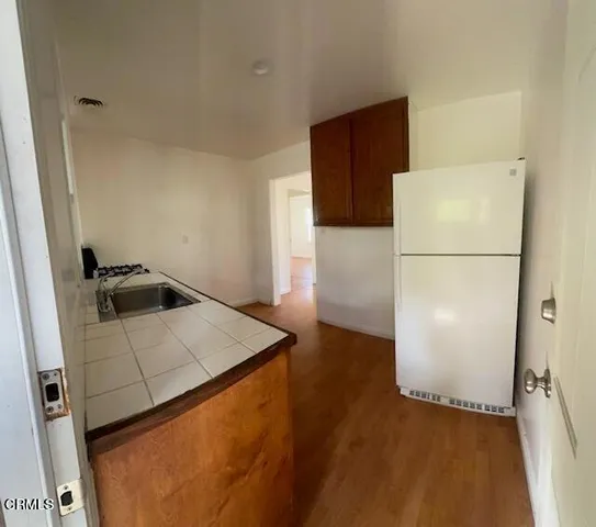 a white refrigerator freezer sitting in a kitchen
