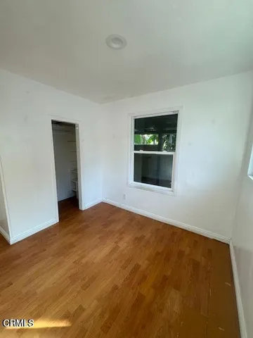 a view of an empty room with a fireplace and a rug