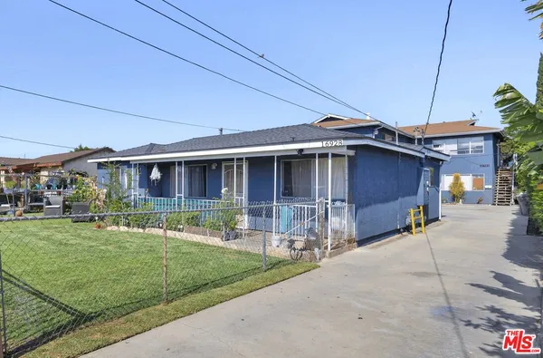 a front view of a house with a yard table and chairs
