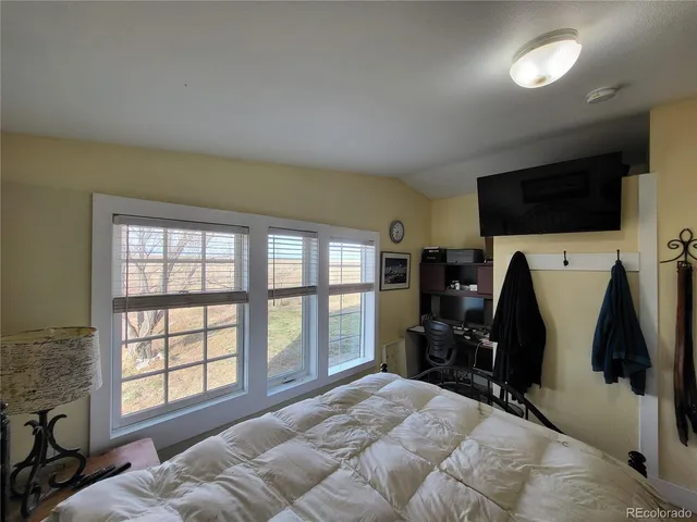 a bed room with a bed and a television