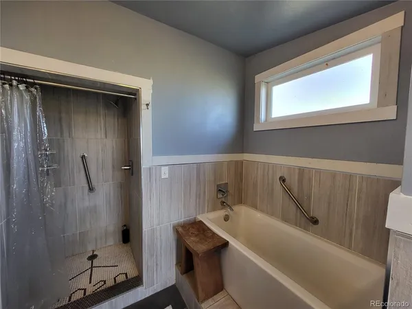 a bathroom with a tub and a shower