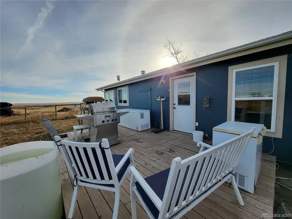 a view of a dining table and chairs in balcony