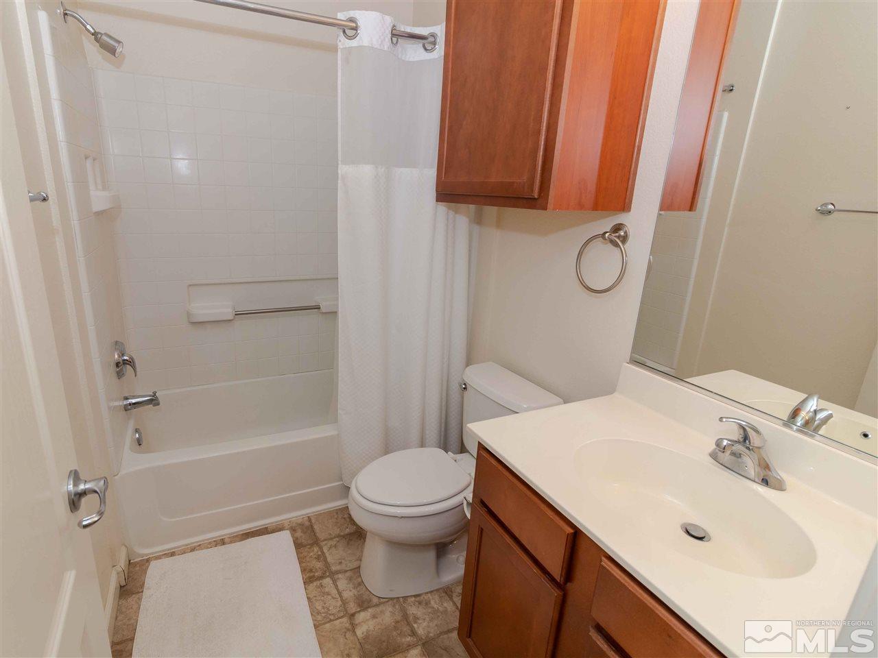 9050 Double R, Unit 1925 Reno, NV 89521 - Photo 13 of 25 a bathroom with a sink a toilet and shower