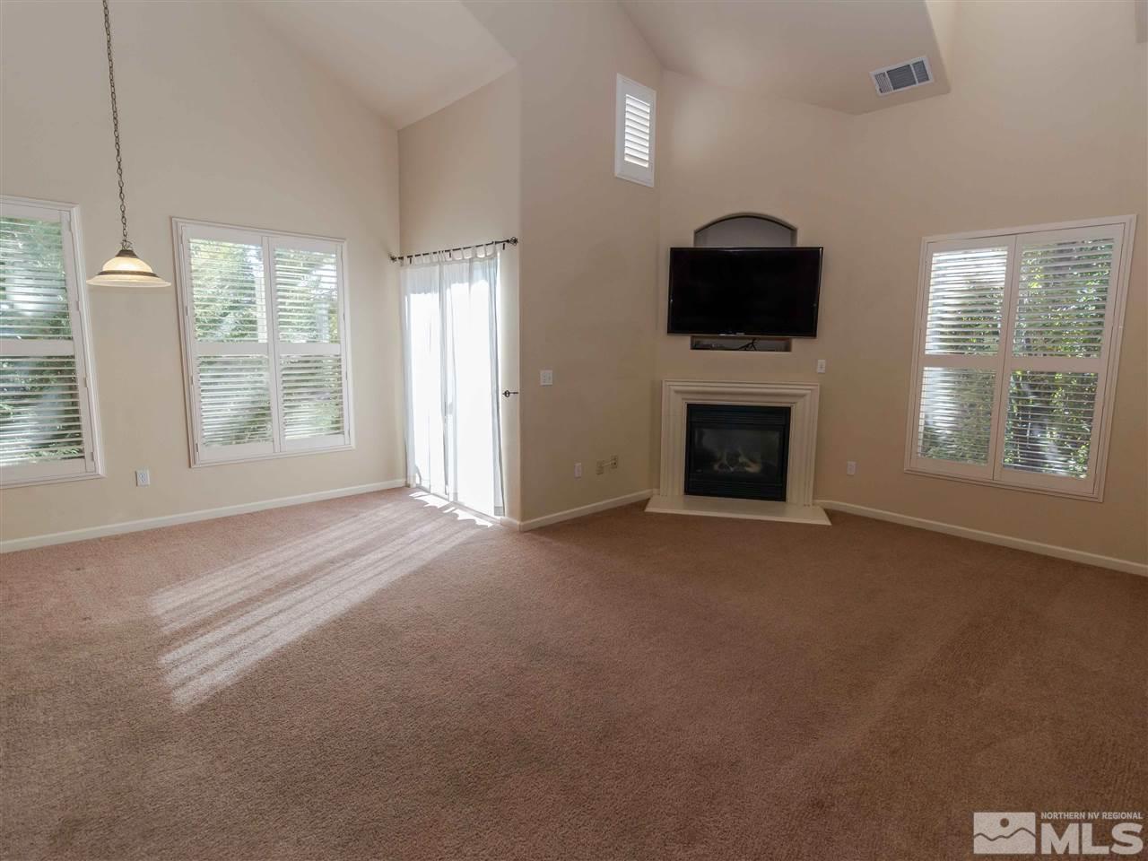 9050 Double R, Unit 1925 Reno, NV 89521 - Photo 2 of 25 a view of livingroom with furniture flat screen tv and window