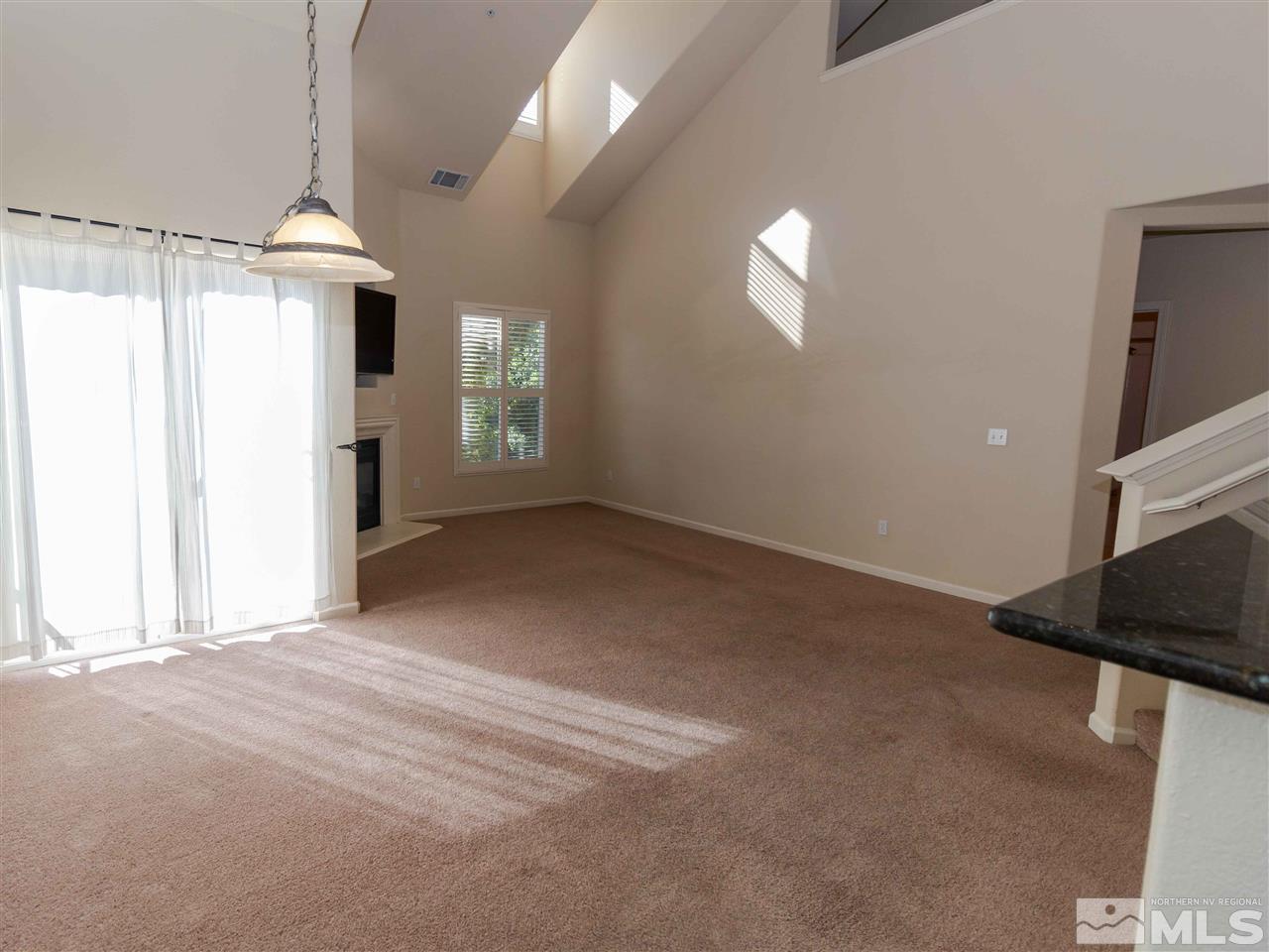 9050 Double R, Unit 1925 Reno, NV 89521 - Photo 3 of 25 a view of a kitchen with furniture and a ceiling fan