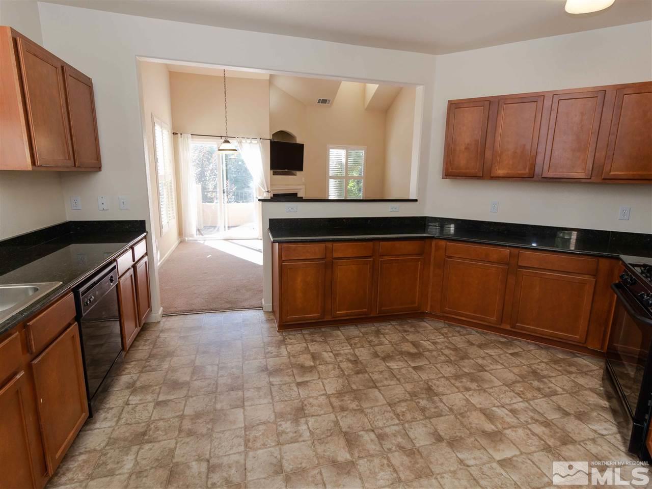 9050 Double R, Unit 1925 Reno, NV 89521 - Photo 6 of 25 a kitchen with stainless steel appliances granite countertop a sink stove and cabinets