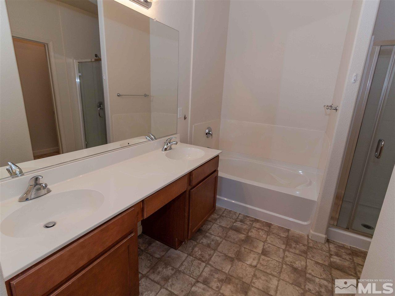 9050 Double R, Unit 1925 Reno, NV 89521 - Photo 10 of 25 a bathroom with a sink a tub and a mirror