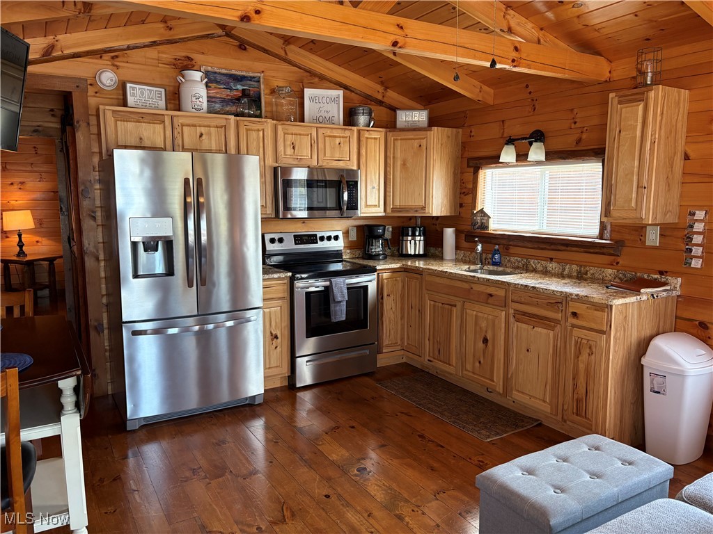 5919 Lake Road West, Unit 7 Ashtabula, OH 44004 - Photo 6 of 29 Kitchen with appliances with stainless steel finishes, wood walls, dark wood finished floors, and wooden ceiling