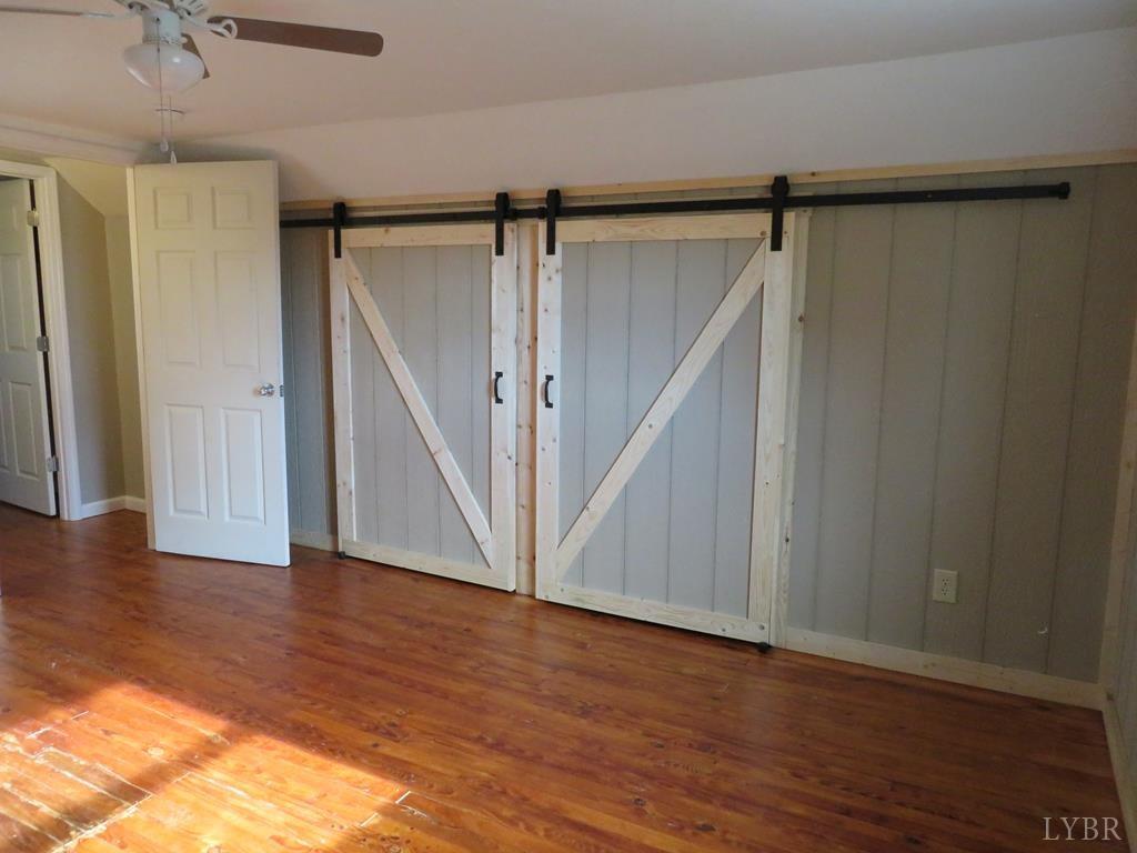 2961 Cotton Patch Road Gretna, VA 24557 - Photo 14 of 24 a view of an empty room with wooden floor and stairs