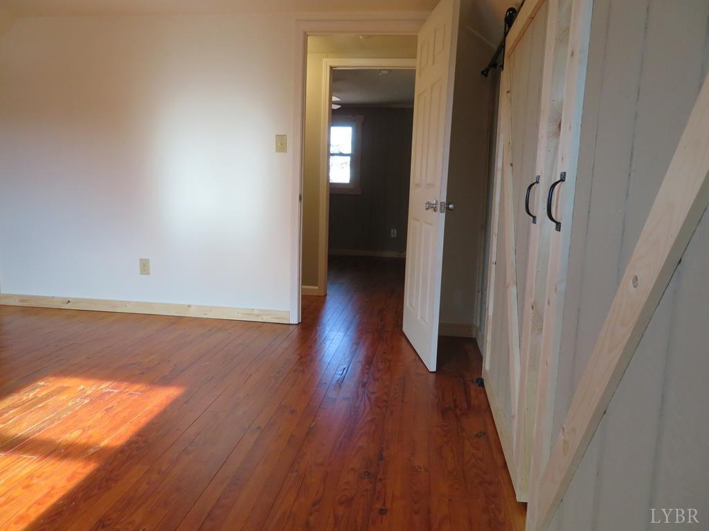 2961 Cotton Patch Road Gretna, VA 24557 - Photo 15 of 24 a view of a hallway with wooden floor
