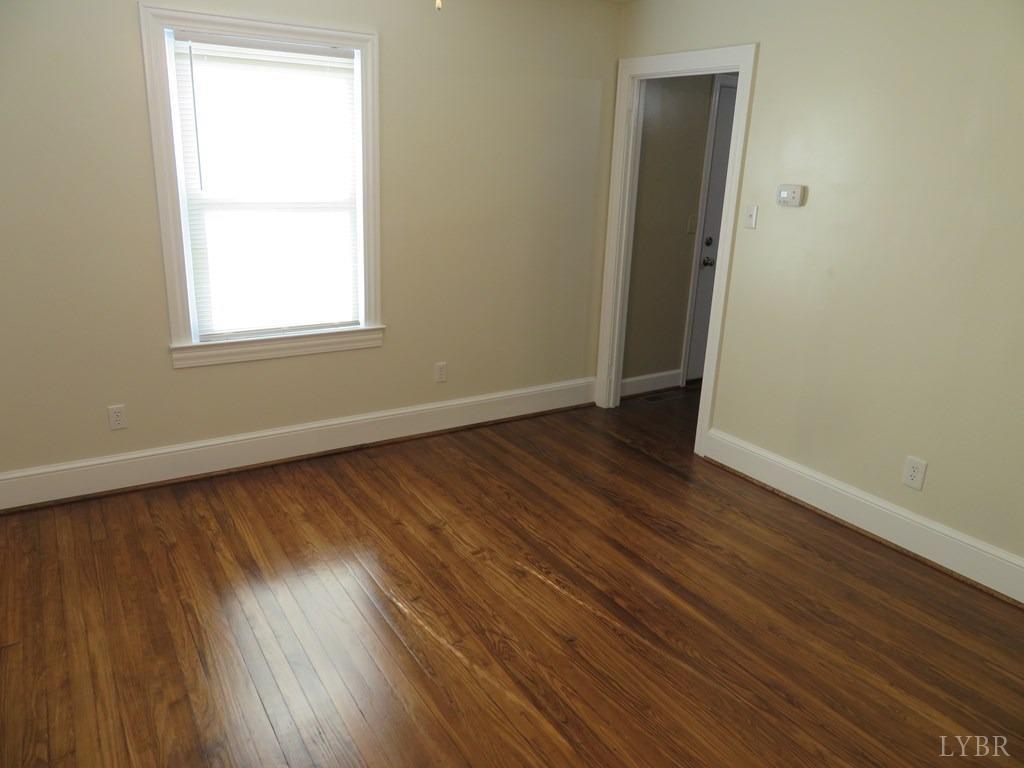2961 Cotton Patch Road Gretna, VA 24557 - Photo 20 of 24 an empty room with wooden floor and windows