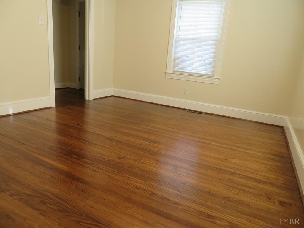 2961 Cotton Patch Road Gretna, VA 24557 - Photo 23 of 24 a view of an empty room with wooden floor and a window