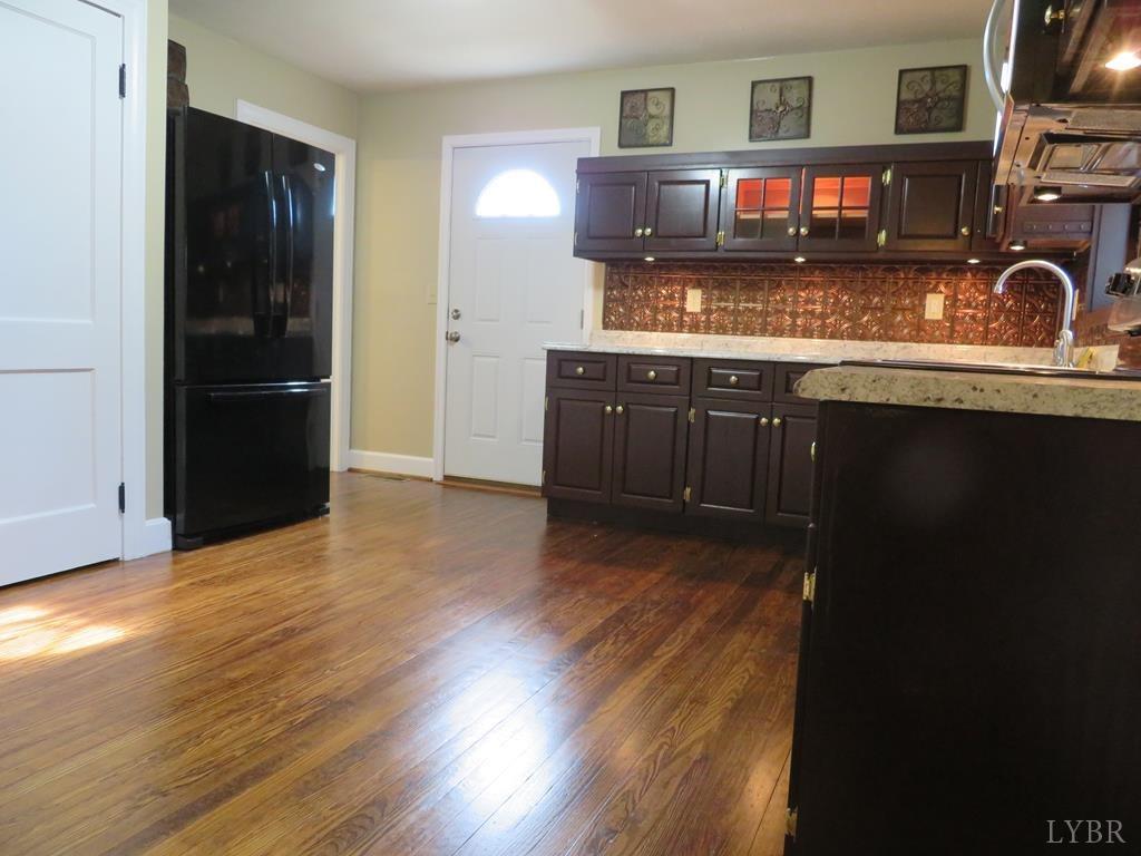 2961 Cotton Patch Road Gretna, VA 24557 - Photo 7 of 24 a kitchen with stainless steel appliances granite countertop a stove and cabinets
