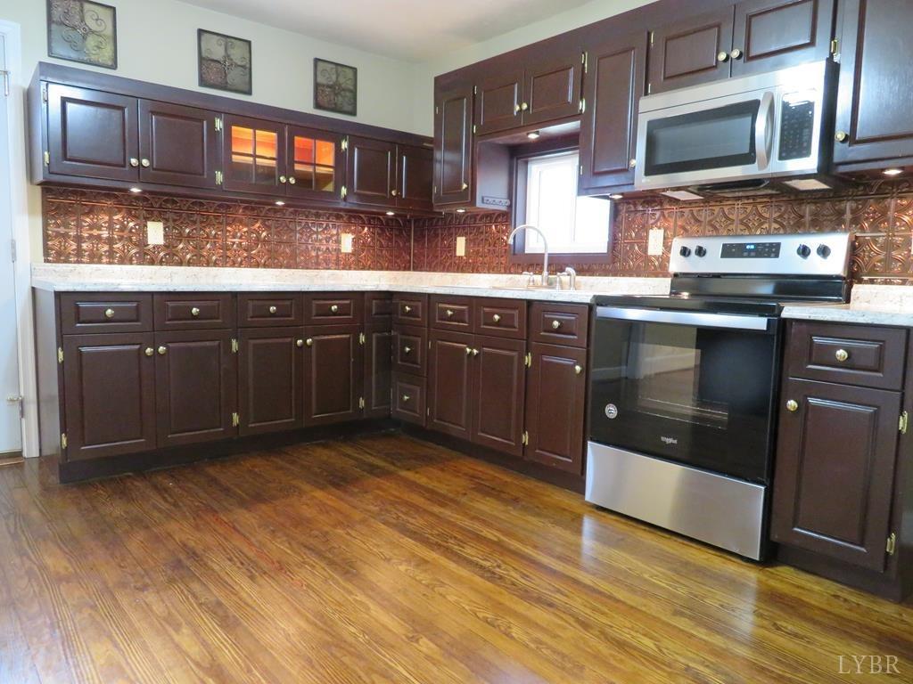 2961 Cotton Patch Road Gretna, VA 24557 - Photo 8 of 24 a kitchen with stainless steel appliances granite countertop a stove a sink and a microwave