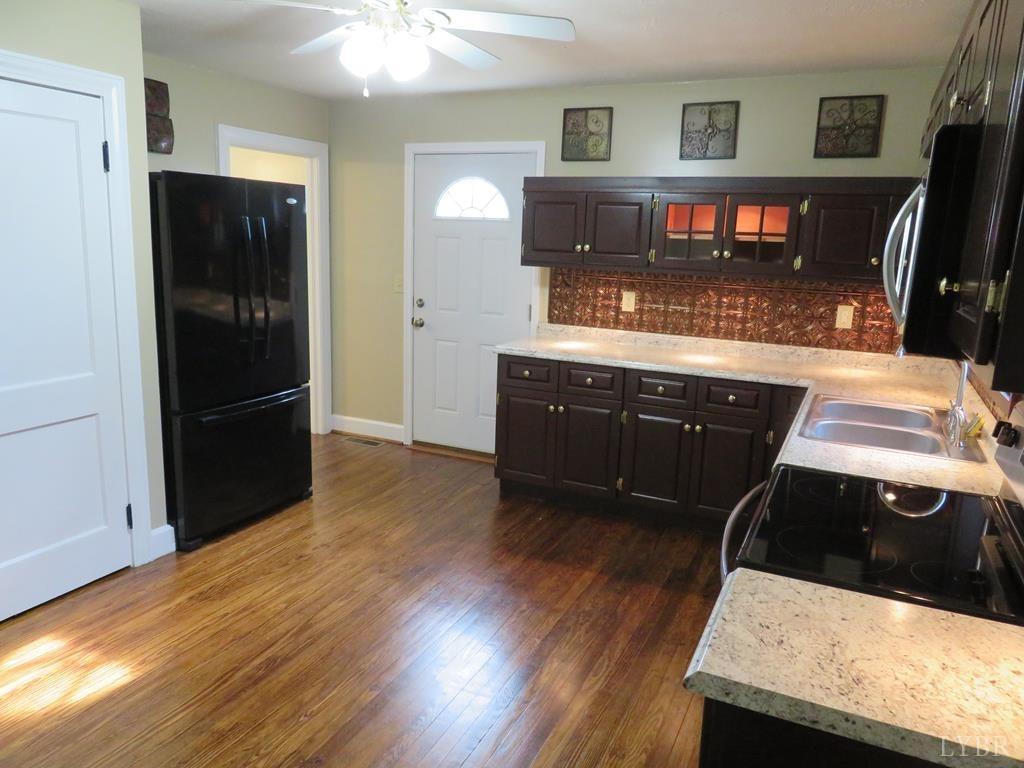 2961 Cotton Patch Road Gretna, VA 24557 - Photo 9 of 24 a kitchen with stainless steel appliances granite countertop a stove and a refrigerator