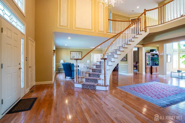 a living room with furniture fireplace and a large window