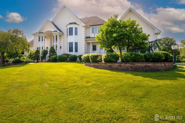 a front view of house with yard and swimming pool