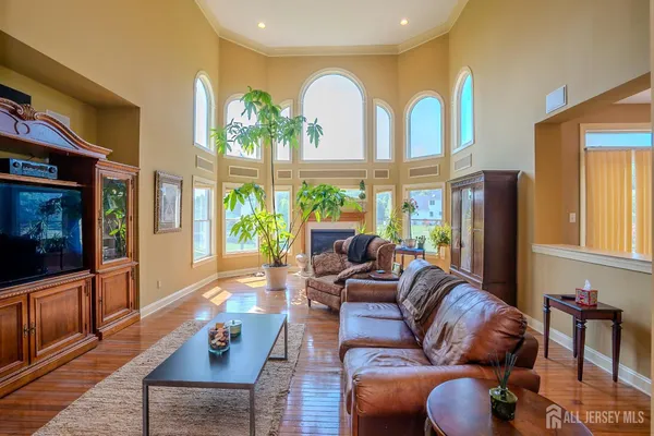 a kitchen with stainless steel appliances granite countertop a refrigerator a stove top oven a sink a counter space and cabinets