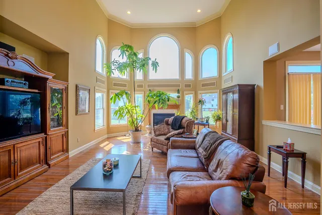 a kitchen with stainless steel appliances granite countertop a refrigerator a stove top oven a sink a counter space and cabinets