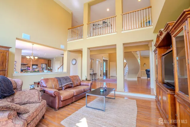 a living room with granite countertop kitchen island furniture and a wooden floor