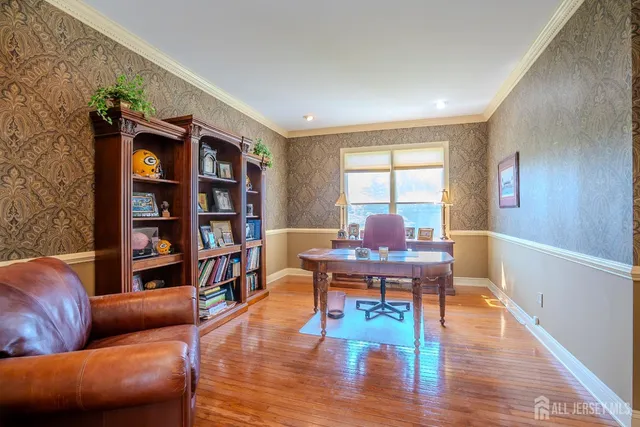 a dining room with furniture entryway and wooden floor