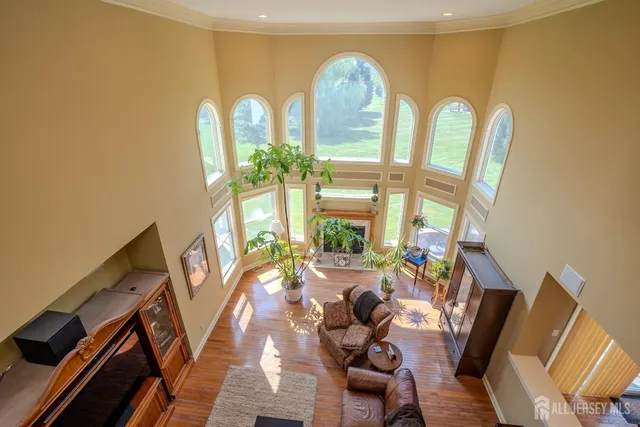 a view of hallway with a large window and chandelier