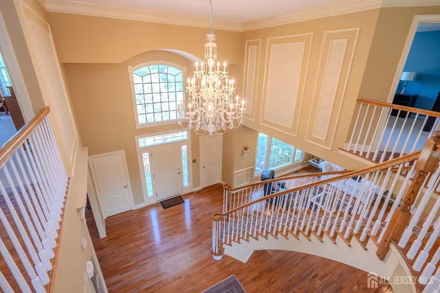 a view of a house with a yard and lake view