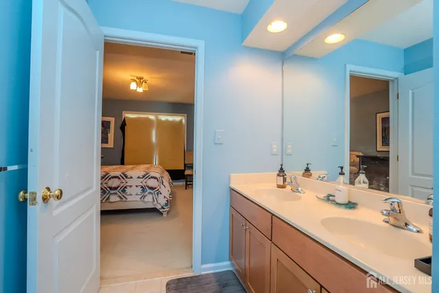 a aerial view of a house with swimming pool and large trees