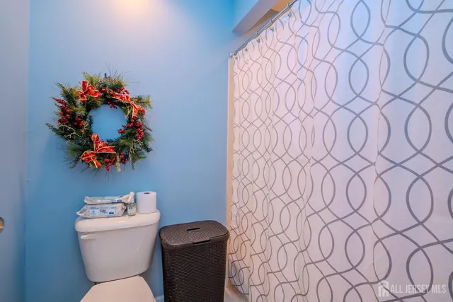 a aerial view of a house with swimming pool lawn chairs and large tree