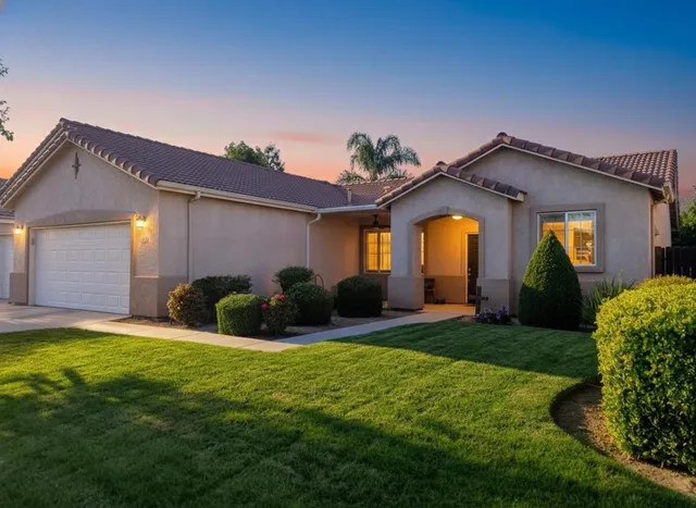 a front view of house with yard and outdoor seating