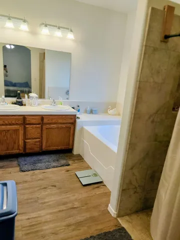 a bathroom with a tub sink and a mirror