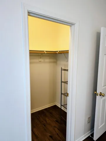 an empty room with wooden floor and a window
