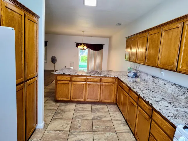 a large kitchen with a sink and dishwasher