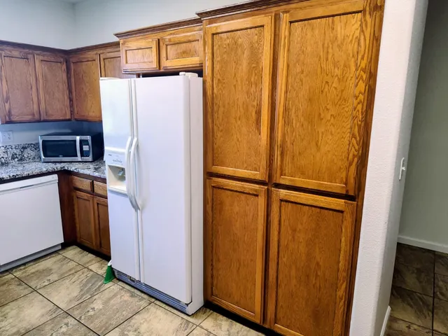 a white refrigerator freezer sitting in a kitchen