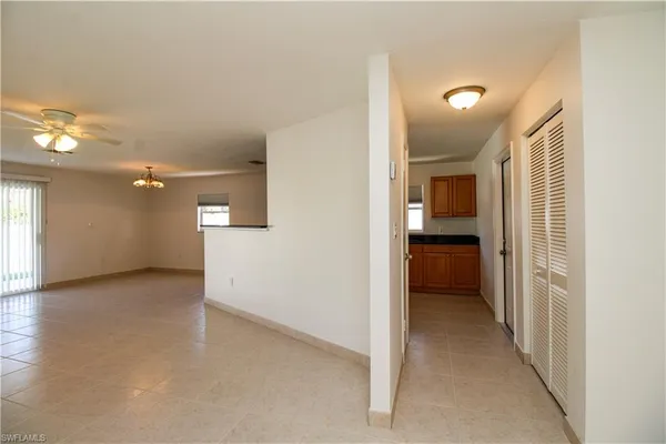 a view of a hallway with a kitchen