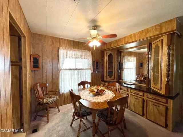 a view of a dining room with furniture and window
