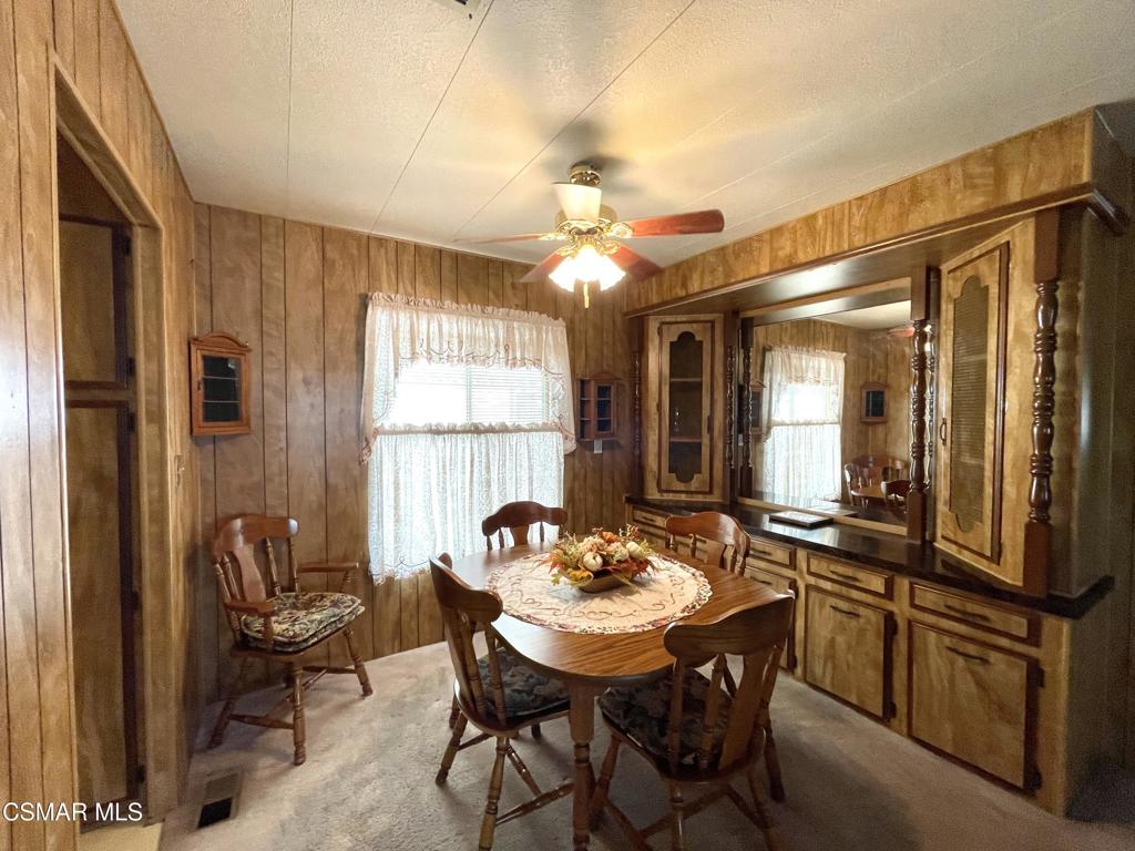 a view of a dining room with furniture and window